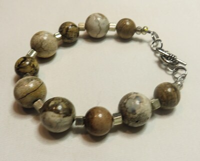 bracelet with various round earth-toned beads with silver accents with toggle closure - image1